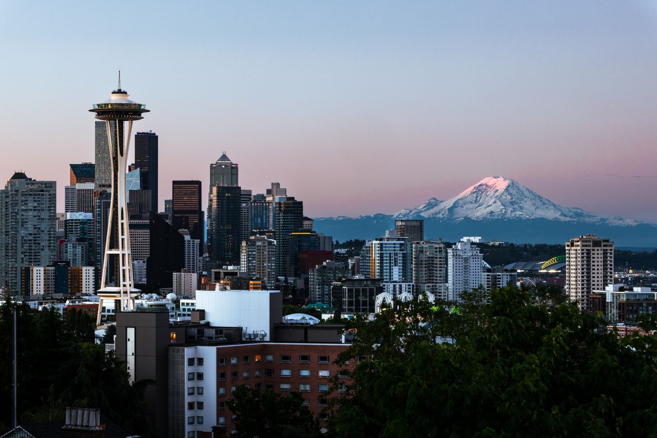 services-img Captivating view of Seattle's skyline featuring the Space Needle and Mount Rainier at dawn.