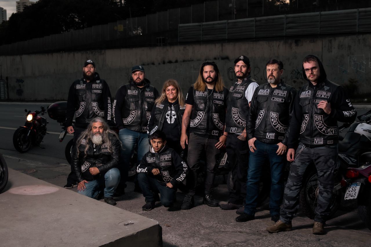 Mastering the First Impression: Your intriguing post title goes here A diverse group of bikers in leather gear posing near their motorcycles on an urban street.