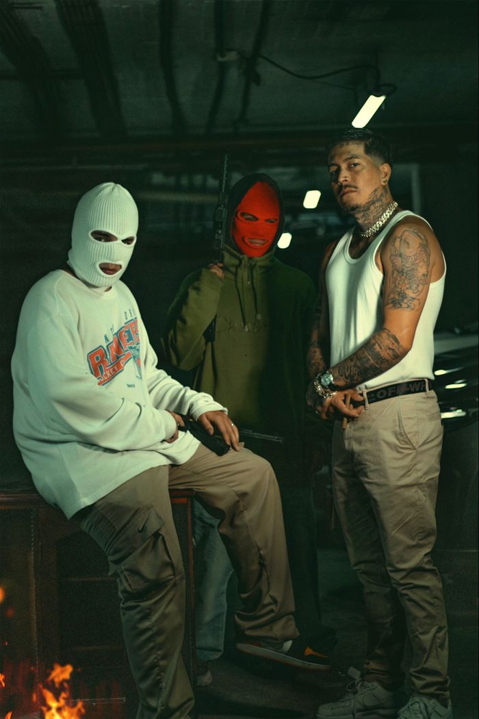 gallery-02 Three men in urban streetwear pose with balaclavas and tattoos.