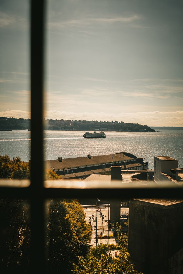 gallery-05 Serene view of a ferry crossing Puget Sound from Seattle waterfront window.