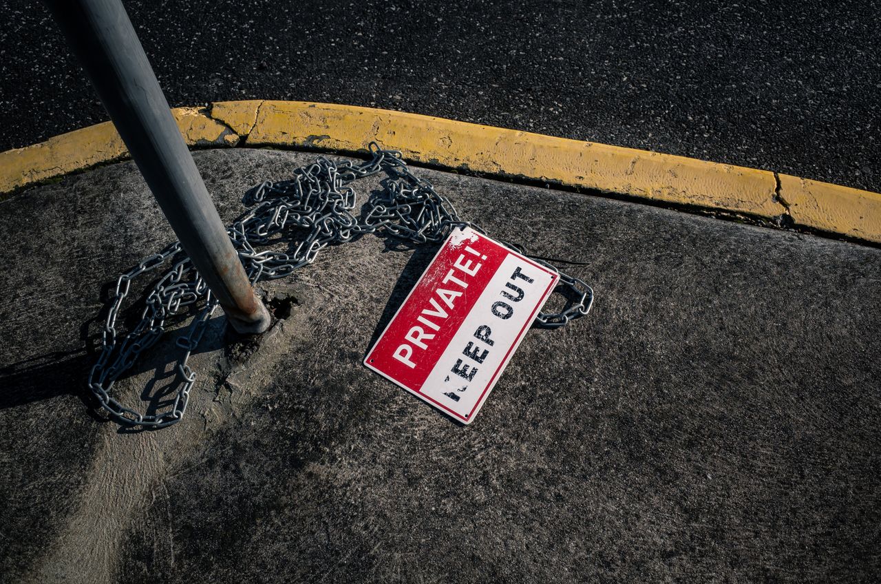 Crafting Captivating Headlines: Your awesome post title goes here A chained 'Private Keep Out' sign lies on an urban sidewalk, emphasizing security.